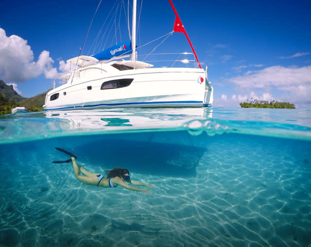 Tahiti yacht charter vacation with person swimming