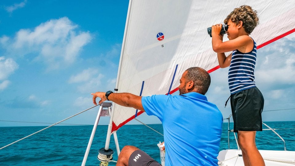 Sailing vacation with children, keeping an eye out for dolphins