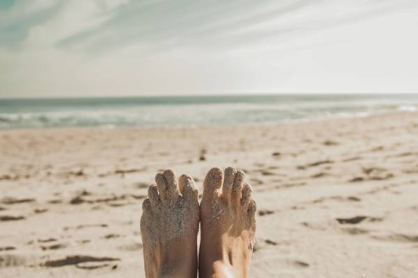 womans feet on beach